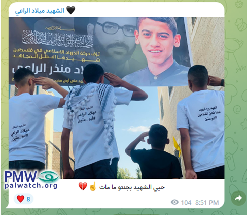 Children salute picture of teen PIJ member, wearing shirts in his honor
