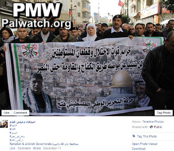 Ghannam holds poster calling for the continuation of the “resistance until victory”